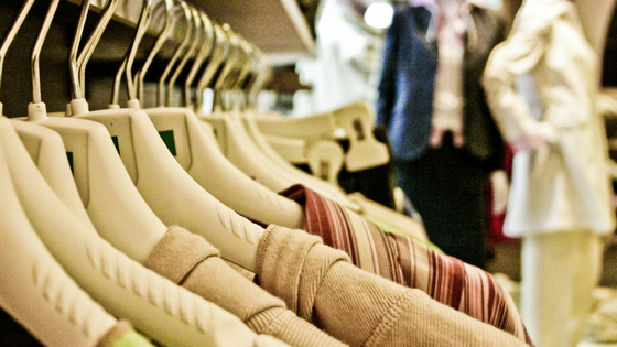 Hangers. A slelection of beige/nude clothing hanging on a rail.