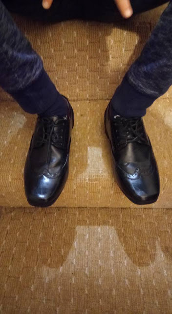 Shoes. George's feet wearing smart shoes.