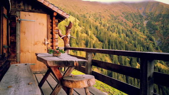 Cabin in woods. A cabin with a decked area with a huge view of the woods.
