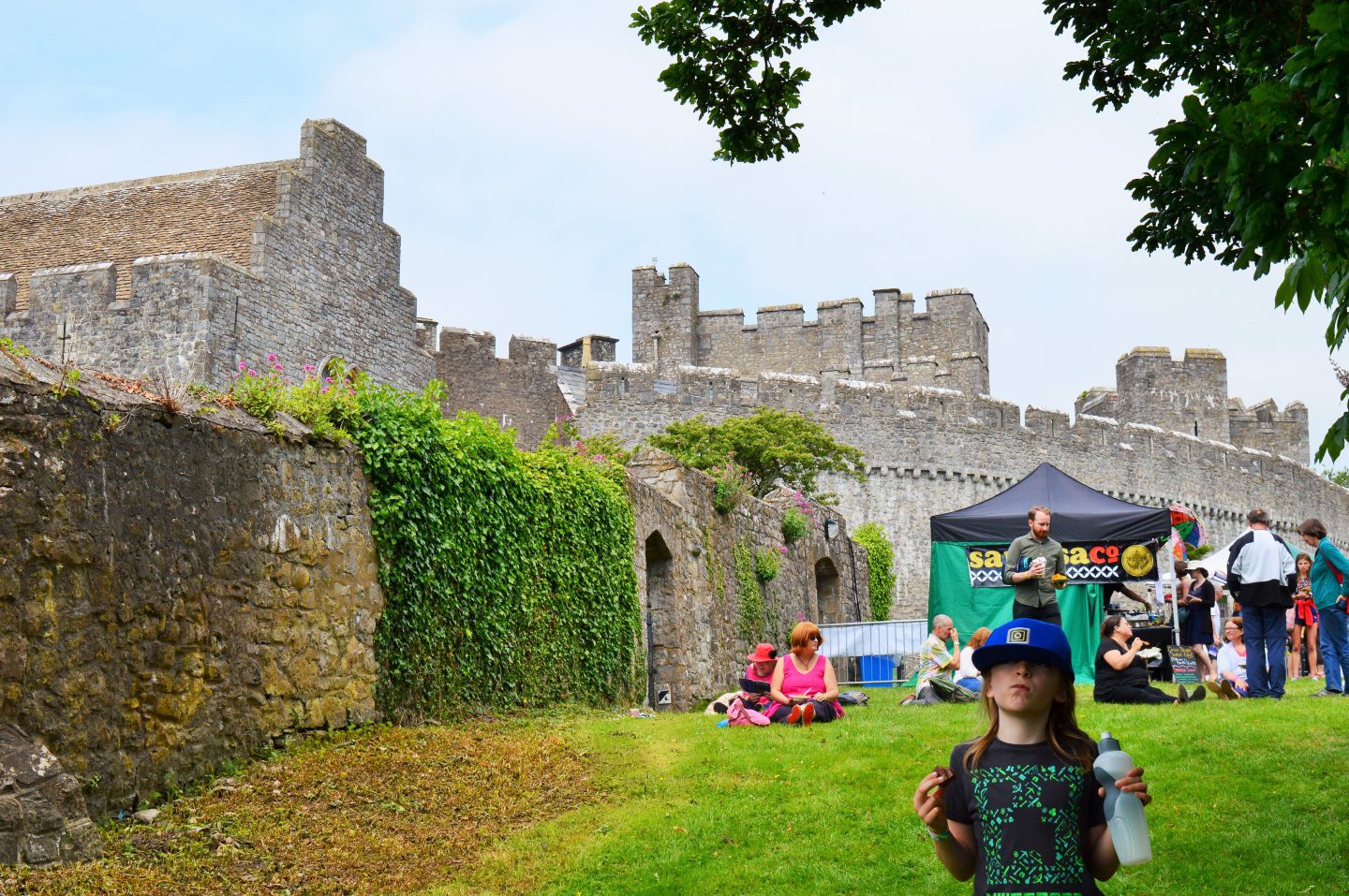 A boy thinking with the background of a castle at Beyond the Border.